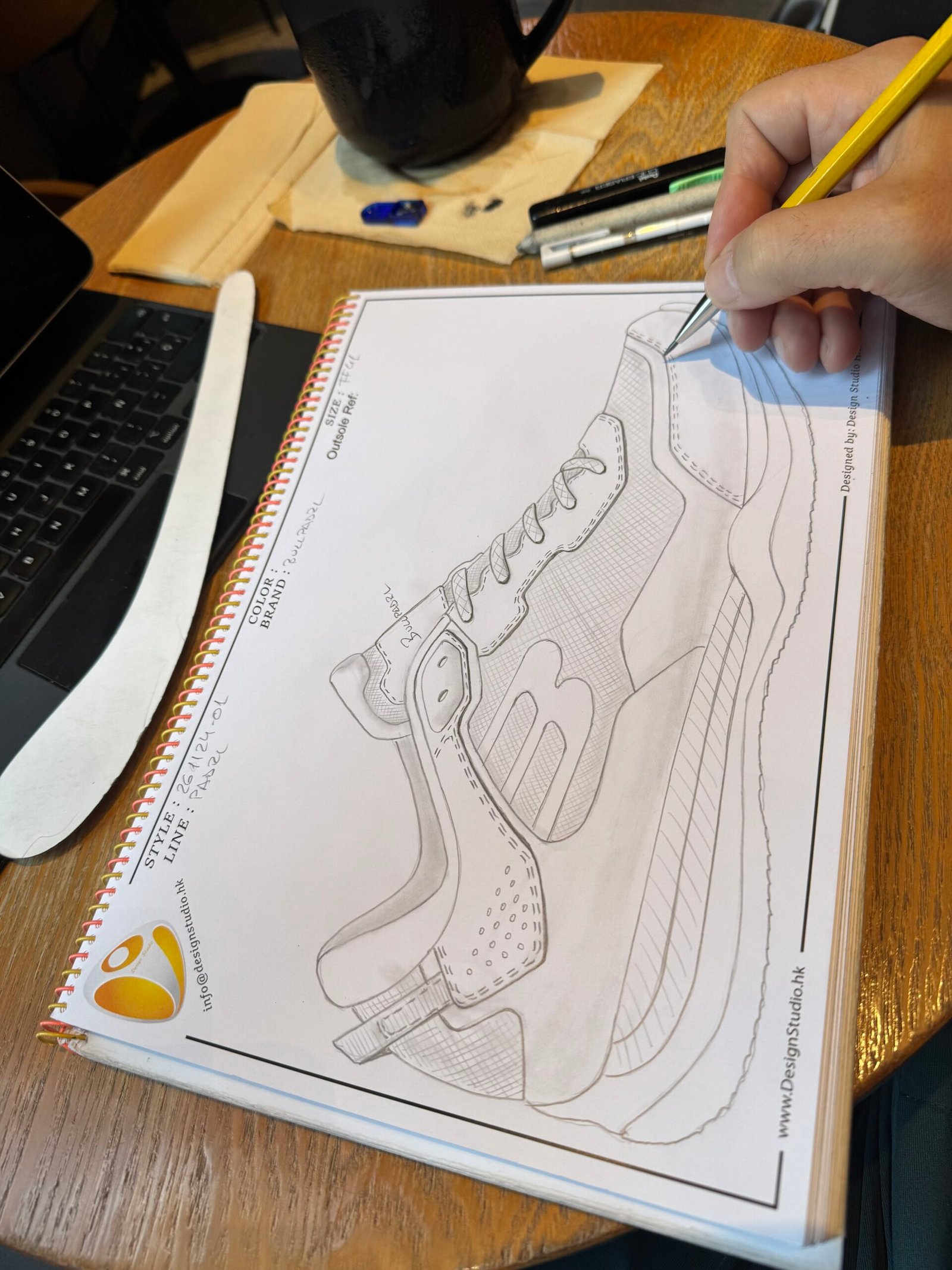Hand-drawn sneaker design concept sketch showing early footwear ideation, proportions and creative exploration in a professional design notebook.